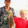 Father and son fishing team; David and Dawson Chandler of Conroe, TX with Dawsons 1st flounder caught at Rollover.