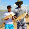 Joe Hamilton with son Jacob of Spring TX show off their reds (jacobs first) caught on mud minnows.