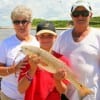 Ken and Barabara Taylor flank great grandson Liam Beausoleio of Rollover at the Bay hefting his redfish.
