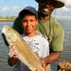 Joe Hamilton and son Jacob with a nice red jacob caught on finger mullet.
