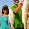 Tiffany and Jes Sloan of Sugarland, TX caught this 21 inch and 33 inch redfish on finger mullet.