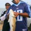 Mr. and Mrs. Healy from Sugarland, TX heft this nice red caught on finger mullet.