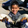 IMG_9162- Seven yr old Tommy Banks of Houston hefts 2 bull croaker headed for the fish fry-