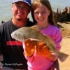 Father and Daughter;Jeramie Ibara of Houston helps 9 yr old Arianna with her very first fish  caught at Rollover.