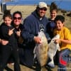 The Mata family of  Kilgore, TX give a thumbs up for their dads big drum he caught and  released on shrimp.