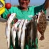 Stacy Crews of Crystal Beach wadefished Rollover bay with live shrimp for this limit of specks and a nice flounder.