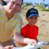 Dad and son, Ramone Ecnenadia of Katy, TX hefts 9yr old Ryan's Zebco caught blacktip shark .