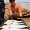 Dustin Platt of Dayton, TX shows off a surf catch caught on soft plastics and mirror lures