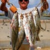 Dallas angler Henri Fontenot hefts 5 specks, which include a 24, 23, and 22 inch trout he took on a T-28