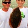 Father and son- Chad Wildman with 10 yr old Shaman heft this nice flounder caught on finger mullet