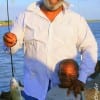 Father and son- Paul Barnell with 7 yr old Demetrion and his first fish at rollover pass