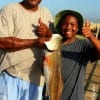 Grandpa and grandson- Ron McGill of Conroe helps Jermiah with his 24 inch slot red
