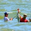 Surf Wader Shows off his catch after fishing mirro-lures on the noon outgoing tide