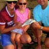 The Knox Family of Lakeview TX help 4 yr old Audrey with her very first saltwater fish, a golden croaker, she caught on shrimp