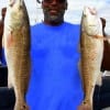 Brian Davis of Humble TX grabbed these two nice slot reds while fishing live shrimp