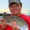 Cameron Young of Vidor TX hefts this nice slot red he caught on a finger mullet