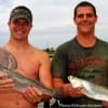 Fishin buds Garrett Vaughan and Casey Mitschow cast gold spoons below the bridge to catch these nice specks