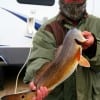 A very chilled Felix Barker of Koontze TX holds up his cold front slot red he took on a chilled finger mullet