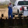 Camaraderie among fishermen, Angler netting a fellow angler's flounder