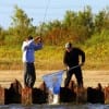 Rollover Pass angler nets a nice flounder for a fellow angler