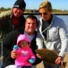 One Yr Old Taylor Schexnider is surrounded by her Daddy, Papa, and Nema displaying a nice flounder they caught