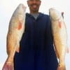 Glenn Guilbau of Houston took these two nice slot reds on live shrimp