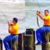 FISH ON! Surf wader uses a piling for catching this nice speck