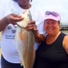 Fishin buds- Demitra Fisher and Ester Ochoa of Houston shows off this nice 23inch slot red Demitra caught on shrimp