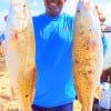 Johnny Lowery of Pearland TX hefts these 26 and 25inch slot reds caught on live shrimp