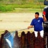 Houston angler Robert Aquirrie nets his speck after catching it on a MirrOlure