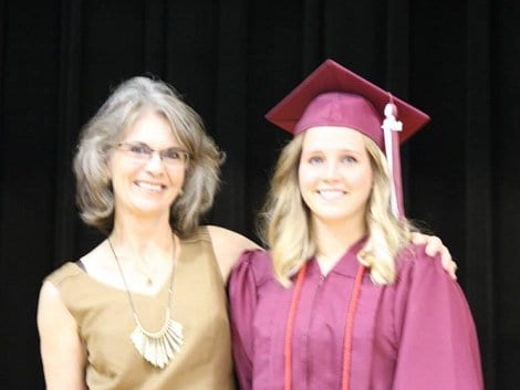 Debby Kahla presenting RE/MAX on the Water-Bolivar $500.00 Scholarship to a 2014 High Island Graduate, Cearra Darnell, during the graduation ceremonies.