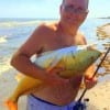 Dennis of Baytown fished croaker in the surf to catch this 23lb bull red