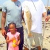 Lawrence Godfrey hefts this 24inch slot red while his daughter Teague and Tim Cornet look on