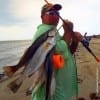 Charles O'Neal of Santa Fe TX waded the surf with live croaker to tether up this near limit of specks