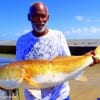 Houston surf angler Adolhus Ardoin fished a finger mullet to catch this 34 inch tagger bull red