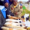 Married fishing team Sharon and Donald Fleming of Dayton TX tailgated these 5 slot reds they caught on shrimp