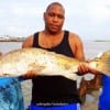 Raymond Shaw and family show off their HUGE 34inch red they caught and tagged while fishing shrimp