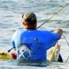 The back of surf wader Charles O'Neal trying to hide his nice stringer of specks- BUT THE CAMERA NEVER LIES!