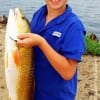 Vidor ISD Student Rob Hudson of Vidor TX hefts this nice 28inch slot red caught on a finger mullet