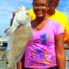 A proud PaPa James helps daughter Loren Henry with her first fish ever caught at Rollover Pass on live shrimp