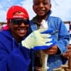 Fishin buds Cynthia Rowan helps 4yr old Kadem Williams with his bull whiting he caught on shrimp