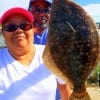 Fishin buds Teresa Gallegos and Dick Taspen of Houston  show off Teresa's nice flounder she took on a finger mullet