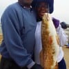 Carolyn and Michael White of Austin cuddled up to this nice 27 inch red she caught on mullet