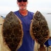 Jackie Bertolino of High Island hefts these two nice flounder caught on Berkley Gulp