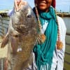 Lauren Henry of Houston hefts this nice 26inch drum caught on finger mullet