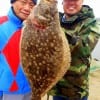 Father and Son anglers Rolly and Jonry Edralin of Sugar Land TX teamed up to catch this impressive 20inch flounder on Berkley Gulp