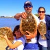 The Peterson Family - Steve - Shelia - and Kady - of Huntsville TX show off thier flounder catch after fishing with mud minnows