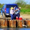 Angler hooks a goodun while his lady nabs it with a net