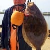 Rollover angler John Peekaboo Goodman lands this nice keeper flounder while fishng a finger mullet