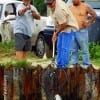 Fellow angler helps net another anglers redfish